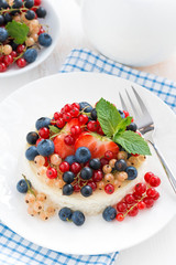 mini cheesecake with fresh berries on a plate, top view