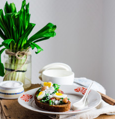 leek with quail eggs and sour cream on rye bread, snack