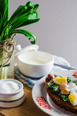 leek with quail eggs and sour cream on rye bread, snack