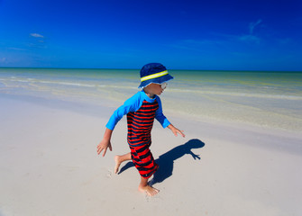 little boy enjoy running on summer beach