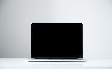 Laptop with blank screen on the table