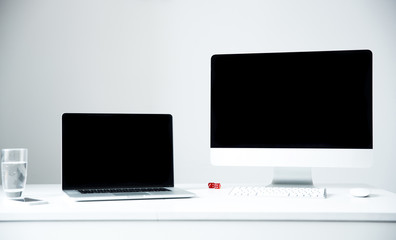 Laptop and PC on the workplace in office