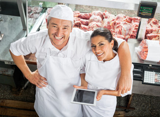Happy Butchers With Digital Tablet In Butchery