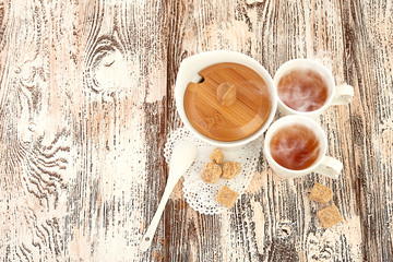 tea with sugar cubes on wooden