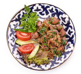 Fried meat with onion in a frying pan
