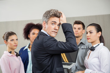 Tensed Manager With Employees At Call Center