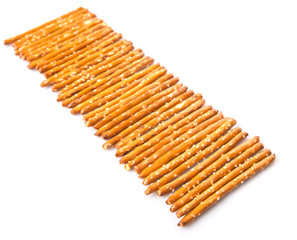 Brown, delicious pretzel sticks in a plastic container