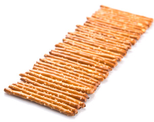 Brown, delicious pretzel sticks in a plastic container