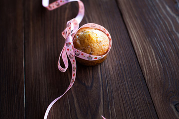 Homemade muffins decorated with ribbon on table