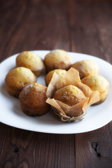 Homemade muffins in plate on wood table