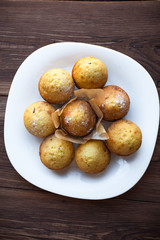 Homemade muffins in plate on wood table
