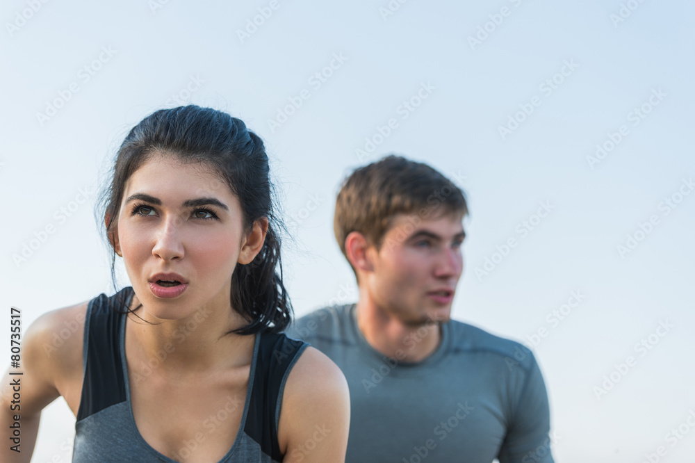 Wall mural cheerful hispanic caucasian couple running