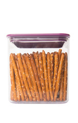 Brown, delicious pretzel sticks in a plastic container