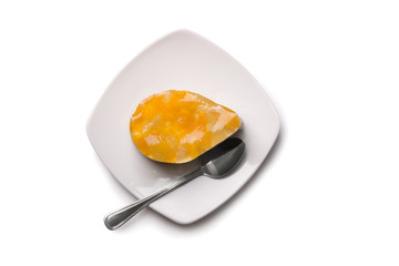 Cake with orange fruit jelly on plate, top view