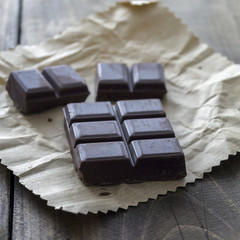 Noble dark chocolate on a wooden table
