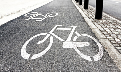 Fototapeta na wymiar White painted bike path signs on asphalt.