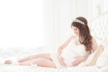 Fototapeta premium happy pregnant woman in a light interior