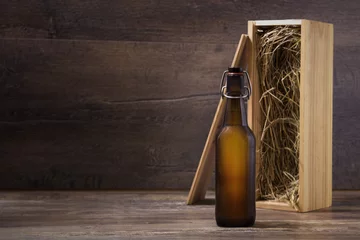 Foto auf Leinwand Craft beer bottle with a wooden gift box on a rustic table © ivanbaranov