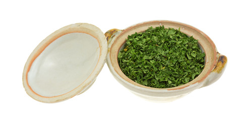 Bowl of dried parsley flakes with lid