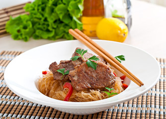 Pork medallions in oyster sauce with noodles
