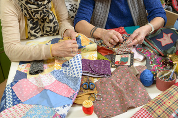 two women working on their quilting - obrazy, fototapety, plakaty
