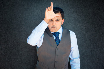 Angry man gesturing you are a loser