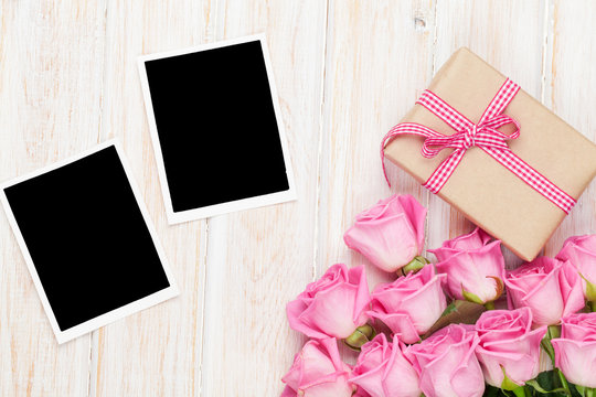 Pink roses and valentines day gift box and two blank photo frame