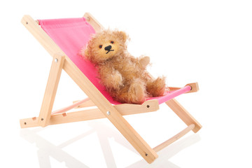 Bear in beach chair isolated over white background