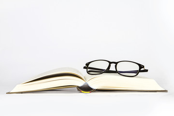 black rimmed glasses placed on opened book
