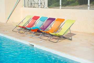 Colorful chairs at swimming pool