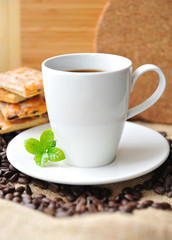 White cup of coffee and tasty cookie