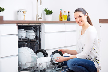 20s woman in kitchen, empty out the dishwasher 5