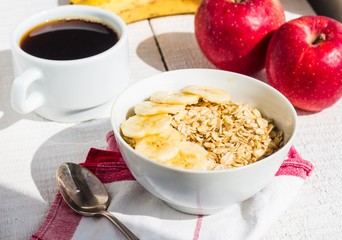 oatmeal with bananas, apples and a cup of coffee