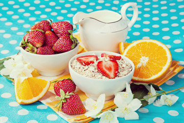 Healthy breakfast. Rolled oats, strawberries and oranges in a be