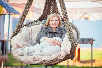 woman in a suspended chair
