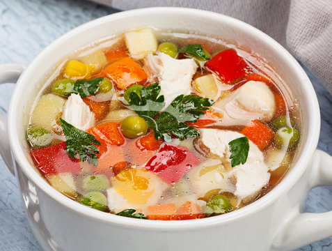 Vegetable soup with chicken on table