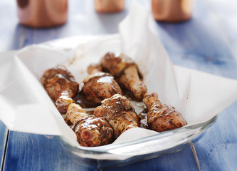 uncooked raw chicken in baking dish with jamaican jerk marinade
