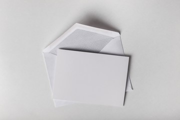 Envelope. Blank card and envelope over grey background