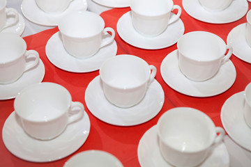 White tea cup on a red tablecloth