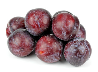 ripe plums on a white background