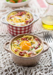 Baked pasta spaghetti carbonara with egg yolk, cheese and bacon