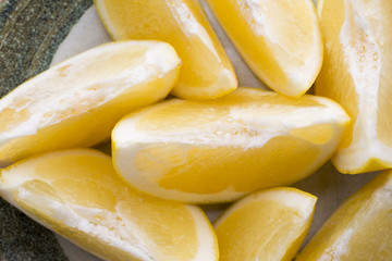 Yellow grapefruit slice on a plate.