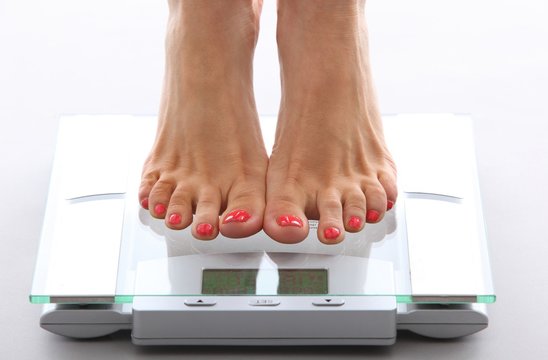 woman feet on a bathroom scale