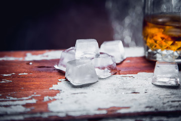 Vintage old photo of whiskey on a wooden rack with ice