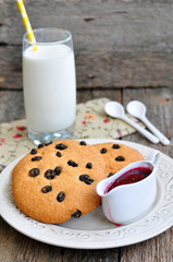 Glass of milk, raspberry jam and handmade cookies