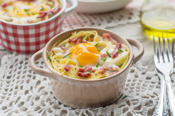 Baked pasta spaghetti carbonara with egg yolk, cheese and bacon