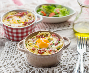 Baked pasta spaghetti carbonara with egg yolk, cheese and bacon