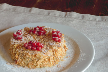 Cake with berries red currant on a white tray