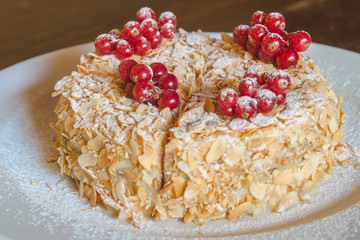 Cake with berries red currant on a white tray
