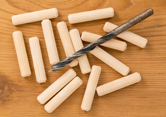 Macro shot of wooden dowels and drill bit
